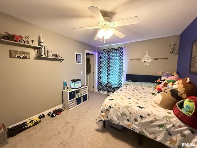 carpeted bedroom featuring baseboards and a ceiling fan