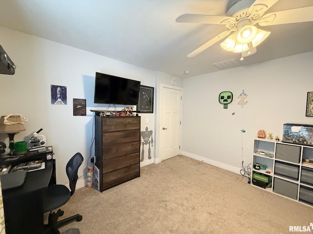 home office with light carpet, ceiling fan, and baseboards