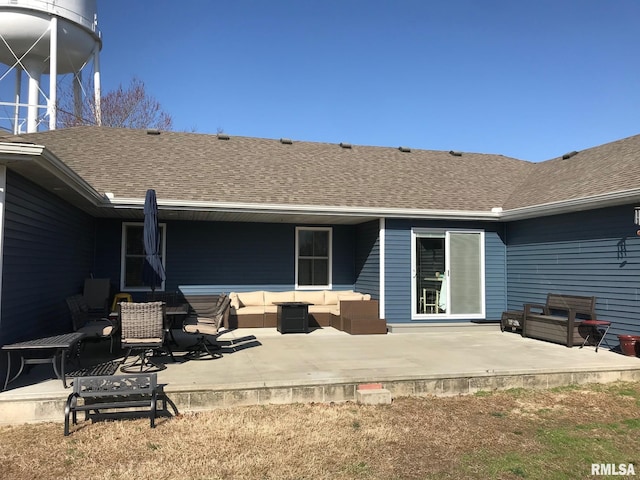 back of house with a shingled roof, a patio area, and outdoor lounge area