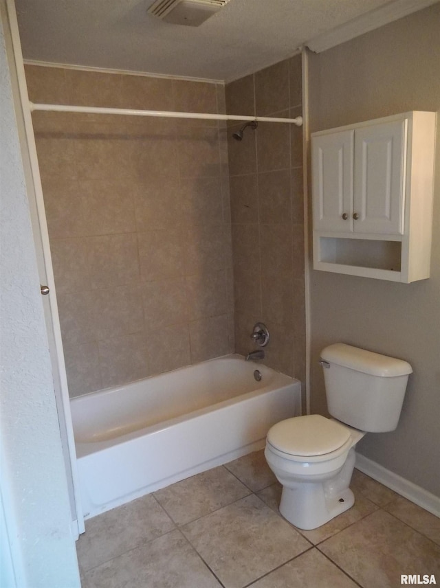 bathroom featuring toilet, visible vents, baseboards, bathing tub / shower combination, and tile patterned floors