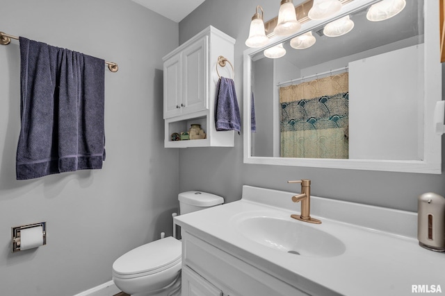 full bath with toilet, baseboards, and vanity