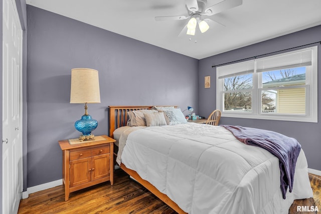 bedroom featuring a ceiling fan, baseboards, and dark wood-style flooring