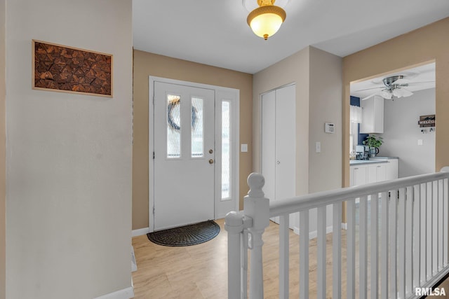 entryway featuring light wood-type flooring and baseboards