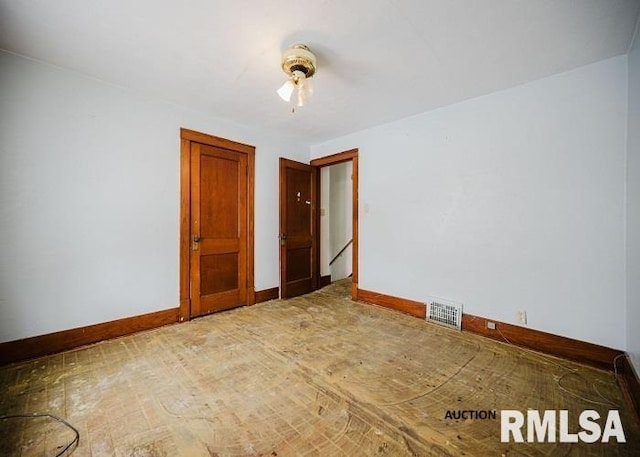 spare room with visible vents and baseboards