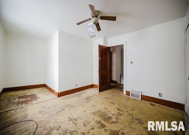 interior space featuring a ceiling fan, visible vents, and baseboards