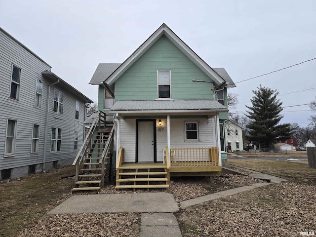 view of front of property featuring stairs and a porch