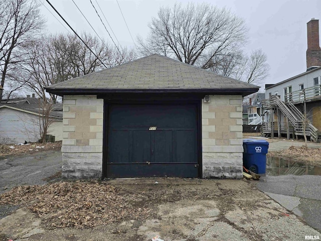 detached garage featuring driveway