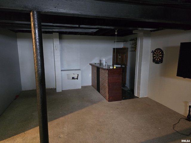 finished basement featuring a brick fireplace