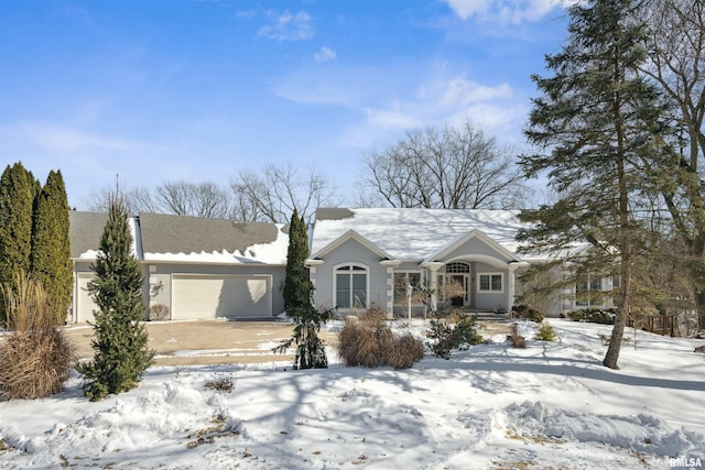 view of front of property with a garage, driveway, and stucco siding