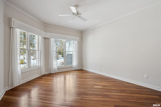 empty room featuring dark wood-style flooring, crown molding, baseboards, and ceiling fan