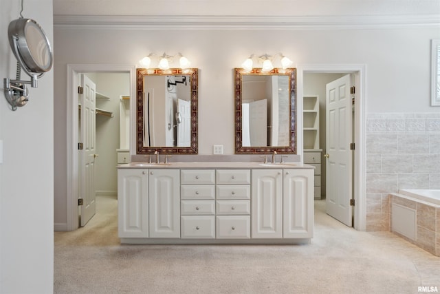 bathroom with crown molding, a garden tub, a sink, and double vanity