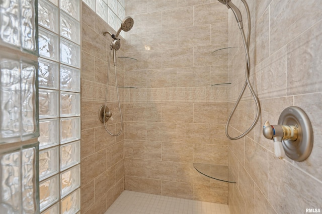 full bath with a tile shower