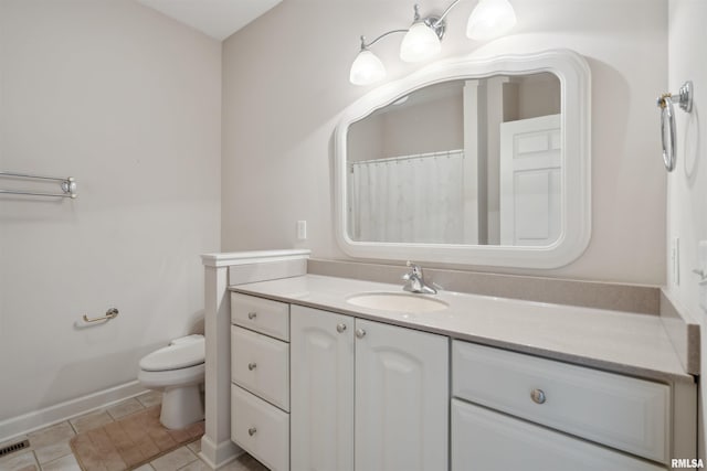 full bathroom featuring toilet, vanity, and tile patterned floors