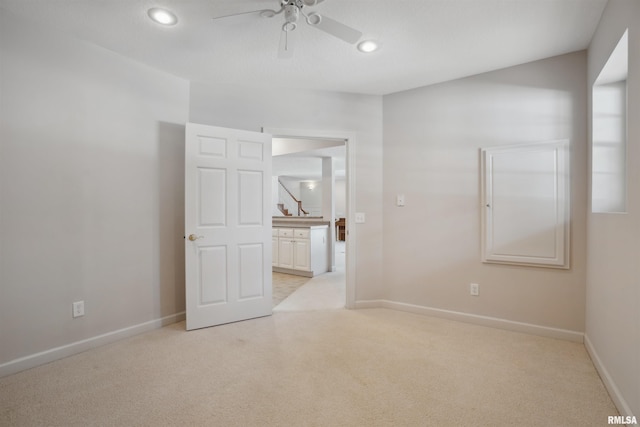 unfurnished room with light carpet, ceiling fan, recessed lighting, and baseboards