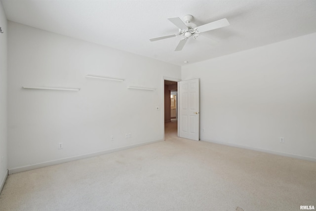 unfurnished room featuring light carpet, ceiling fan, and baseboards