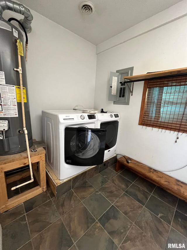 clothes washing area with laundry area, electric panel, visible vents, independent washer and dryer, and water heater