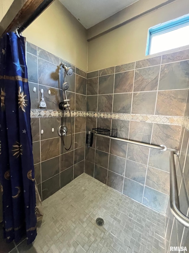 bathroom with tiled shower