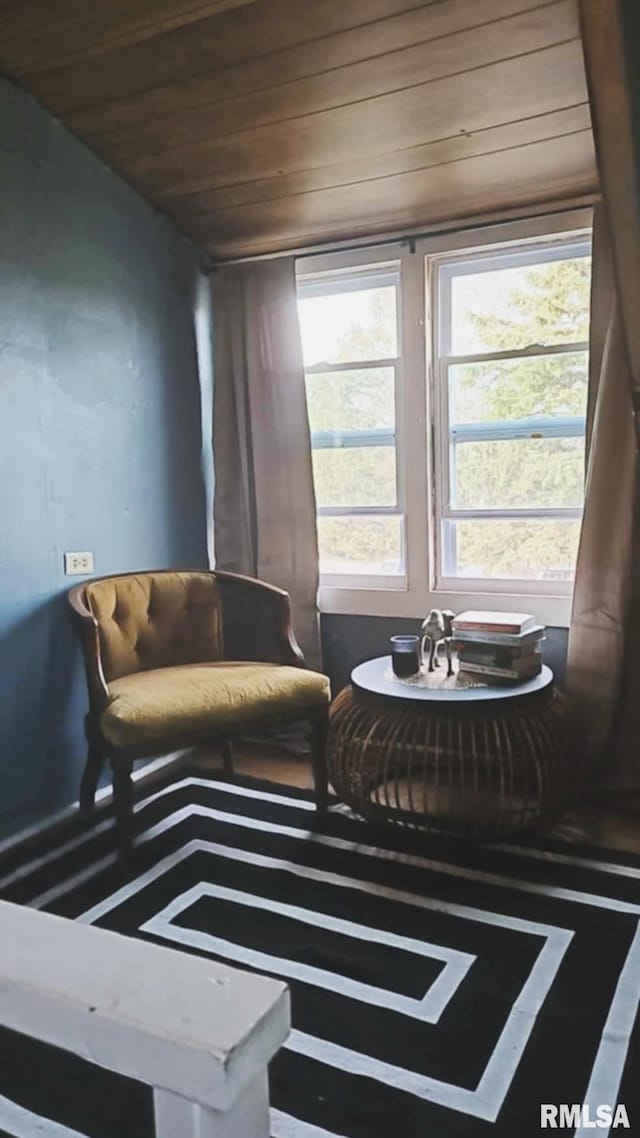 sitting room with a wealth of natural light and wood ceiling