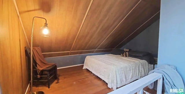 bedroom featuring vaulted ceiling and wood finished floors