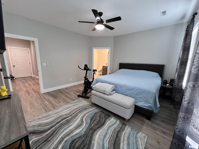 bedroom with baseboards, visible vents, ceiling fan, and wood finished floors