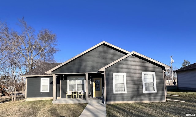 view of front of house with a porch and a front lawn