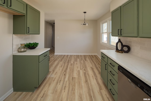 kitchen featuring green cabinetry, baseboards, stainless steel dishwasher, light wood-type flooring, and pendant lighting