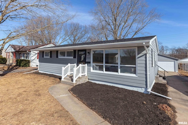 single story home with a garage and an outbuilding