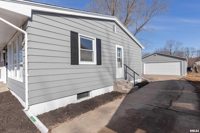 view of side of home with entry steps, an outdoor structure, and a garage