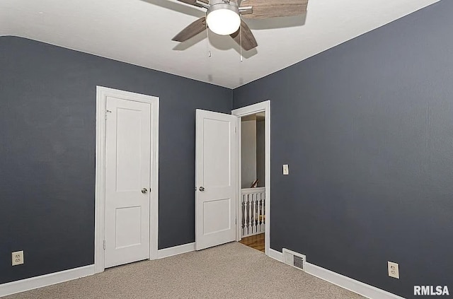 unfurnished bedroom featuring visible vents, baseboards, and carpet flooring