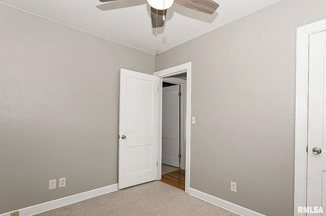 unfurnished bedroom with ceiling fan, carpet flooring, and baseboards