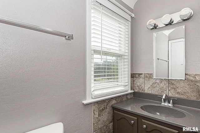 half bathroom with toilet and vanity