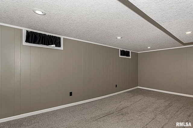 carpeted spare room featuring ornamental molding, recessed lighting, a textured ceiling, and baseboards