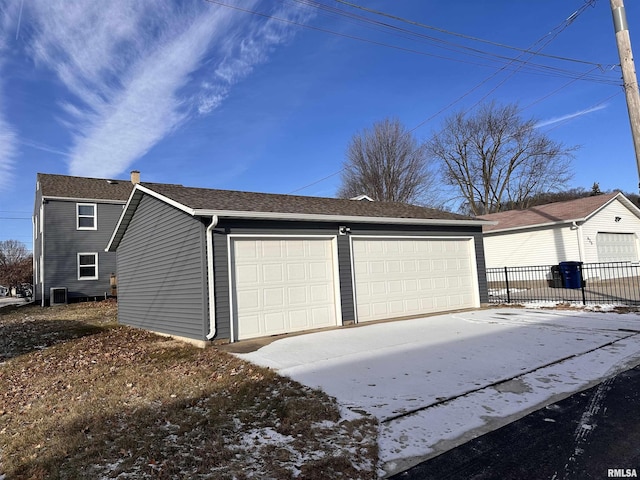 detached garage featuring fence