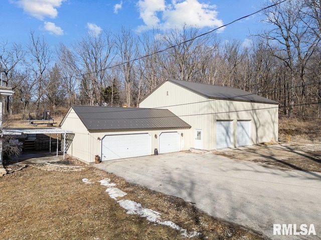 view of property exterior featuring a detached garage