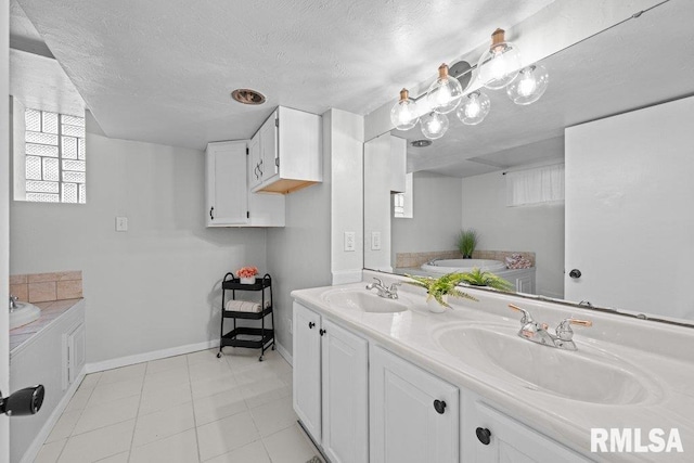 full bathroom featuring a sink, a textured ceiling, and double vanity