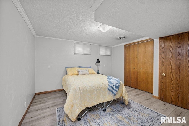 bedroom with crown molding, visible vents, and light wood-type flooring