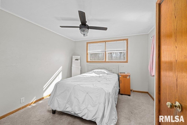 bedroom featuring baseboards, light colored carpet, ornamental molding, and a ceiling fan