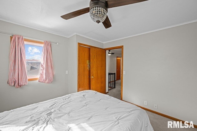 carpeted bedroom featuring crown molding, baseboards, and ceiling fan