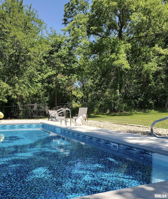 view of swimming pool featuring a fenced in pool, a yard, and fence