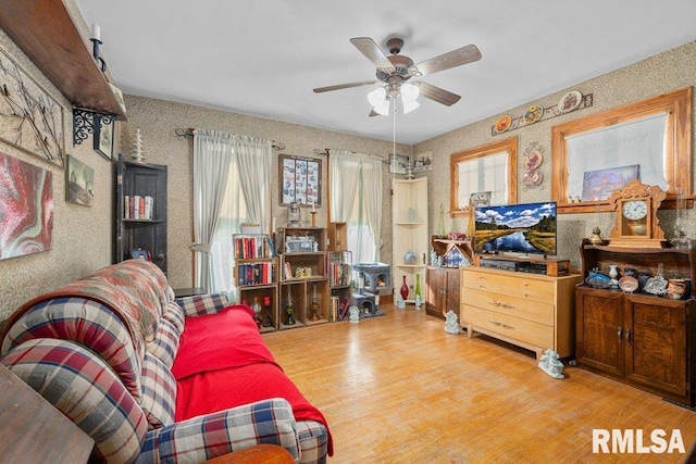 sitting room with ceiling fan and light wood-style flooring