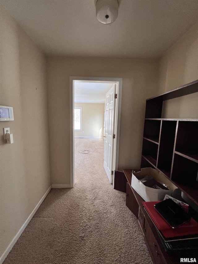 corridor with carpet and baseboards