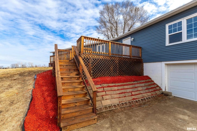 deck featuring stairs and a garage