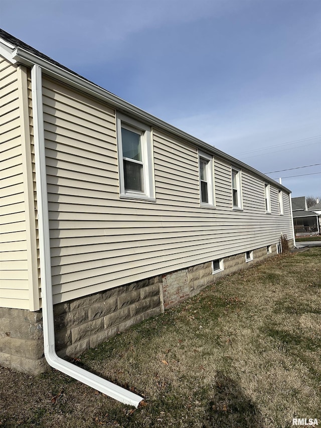 view of side of home with a yard