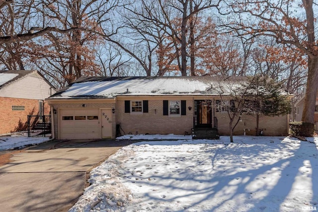 ranch-style home with brick siding, driveway, and an attached garage