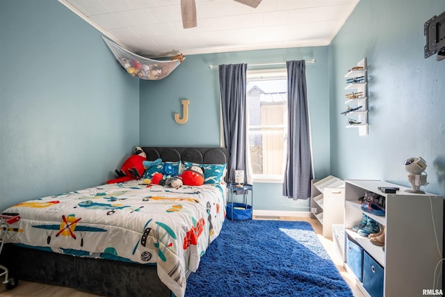 bedroom featuring crown molding and ceiling fan