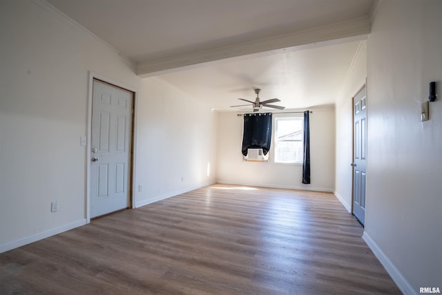 unfurnished room with ceiling fan, crown molding, baseboards, and wood finished floors