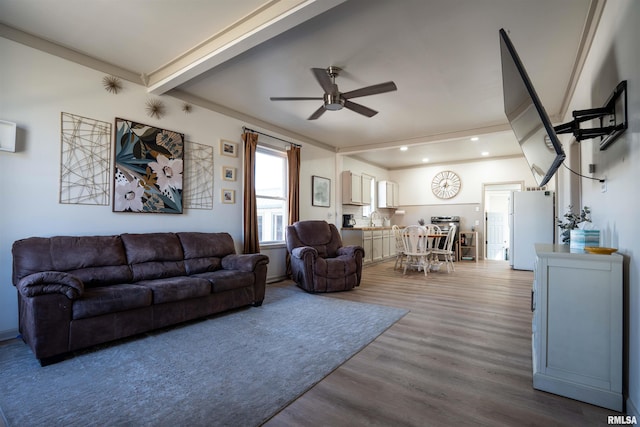 living area with beam ceiling, a ceiling fan, wood finished floors, and recessed lighting