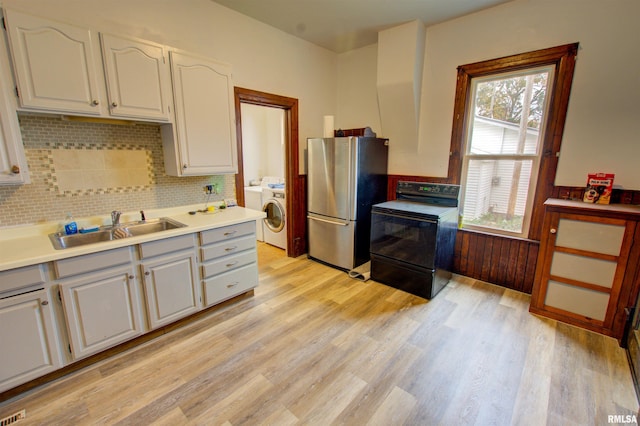 kitchen with white cabinetry, light countertops, electric stove, and freestanding refrigerator