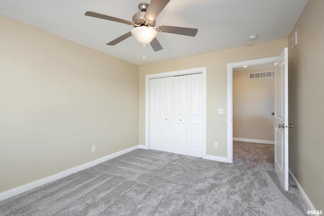 unfurnished bedroom with carpet, visible vents, and baseboards