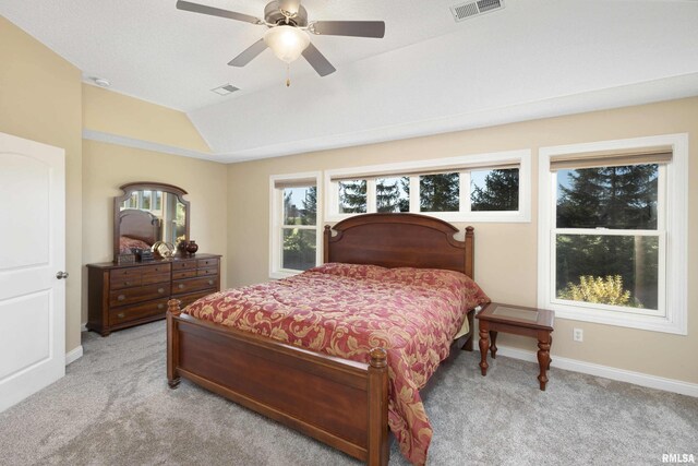 bedroom with visible vents, vaulted ceiling, light carpet, and baseboards